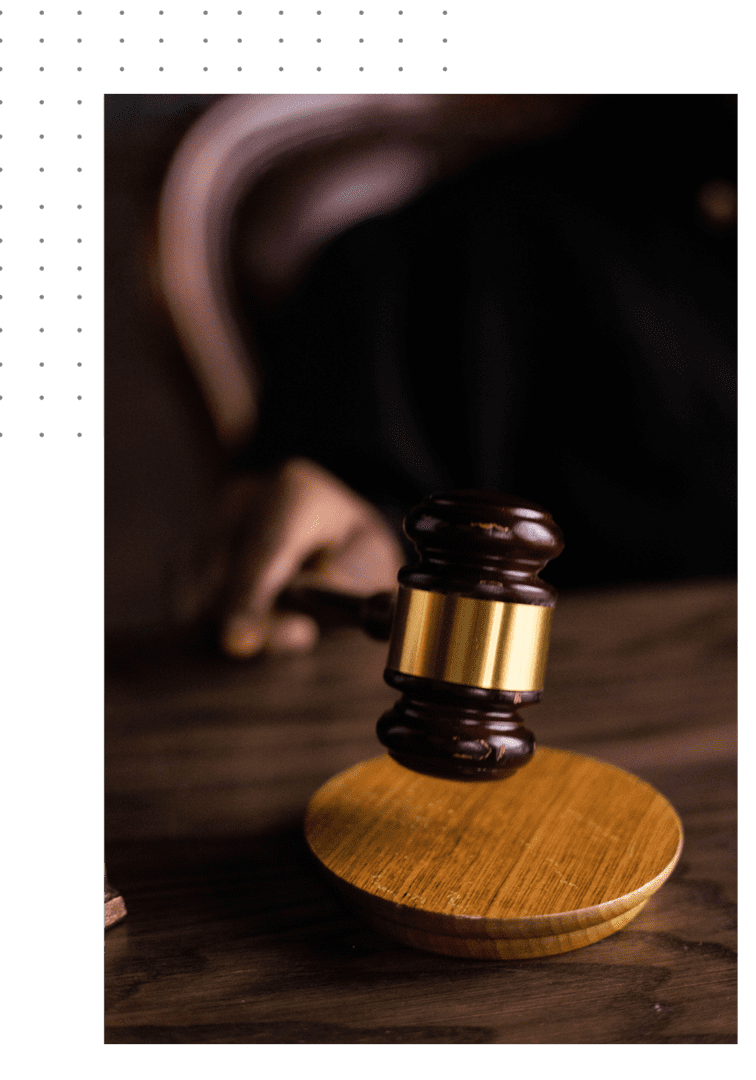 A judge 's gavel on top of a wooden table.